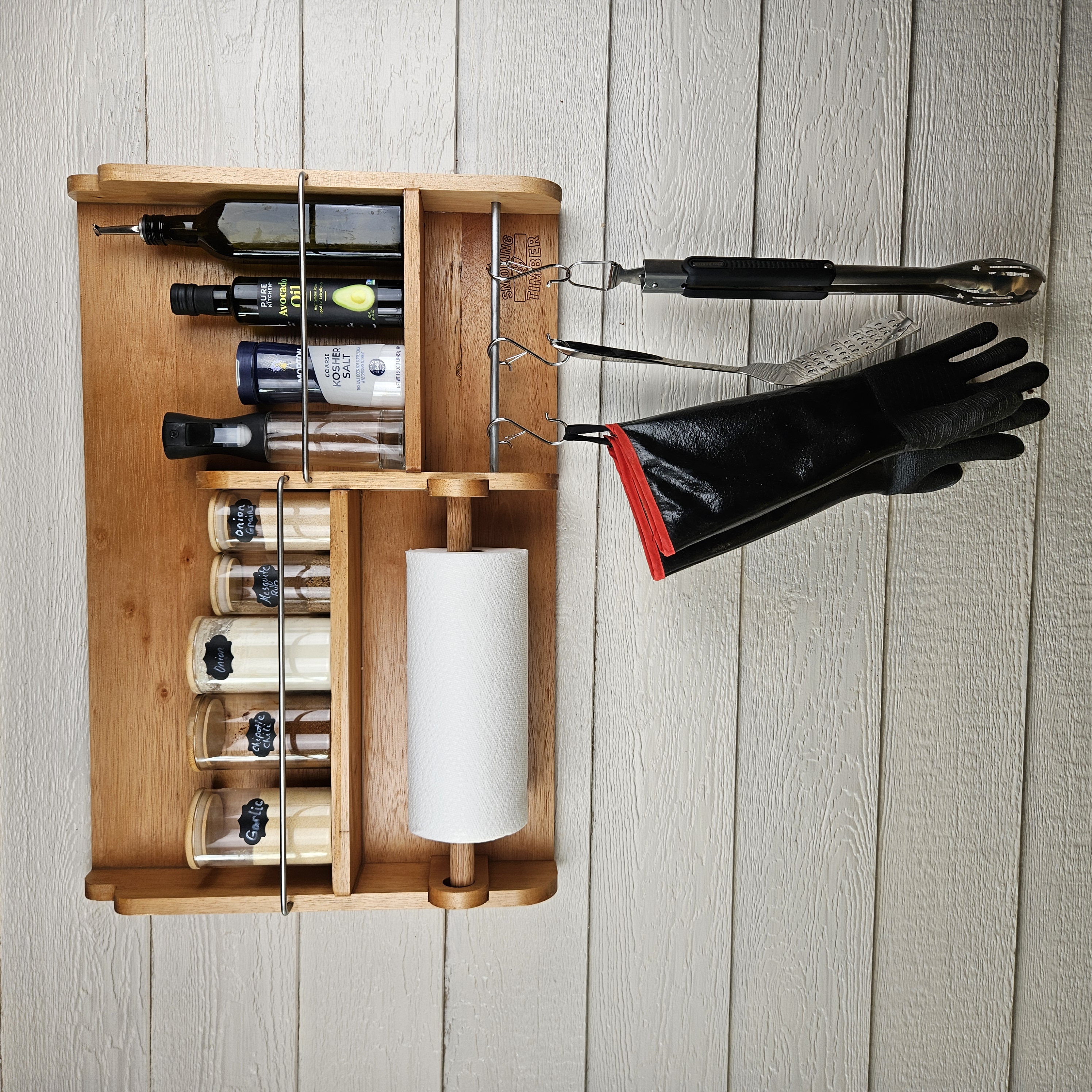 Cedar spice rack mounted on wall holding BBQ rubs