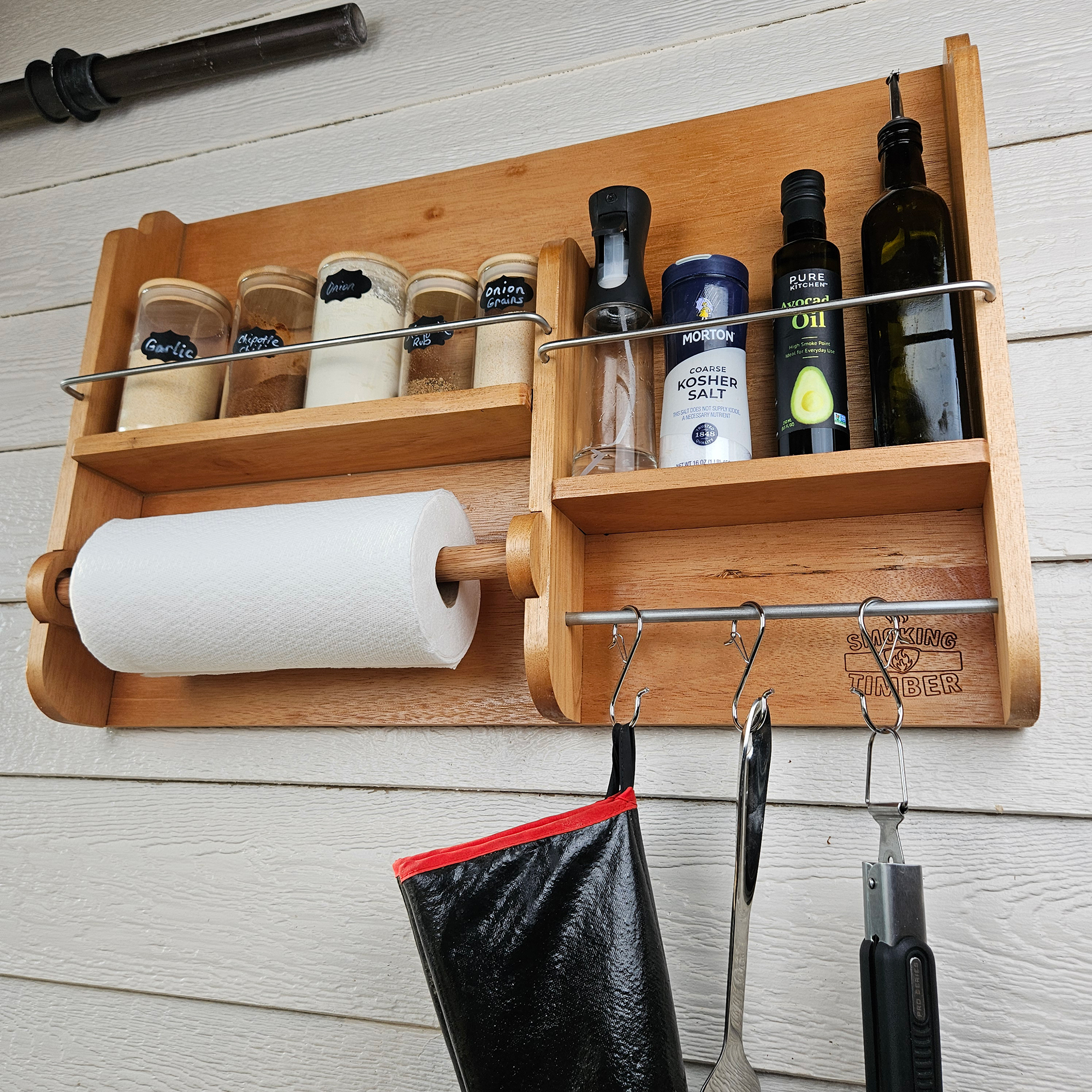 Cedar spice rack mounted on wall holding BBQ rubs