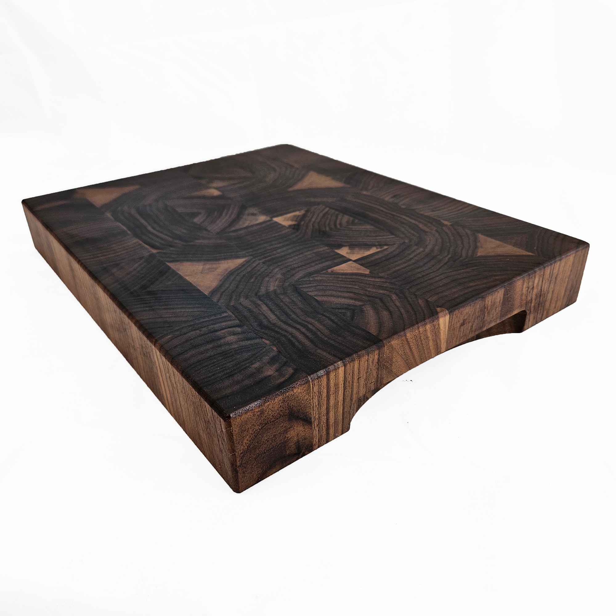 End grain walnut cutting board on countertop for prep and serving