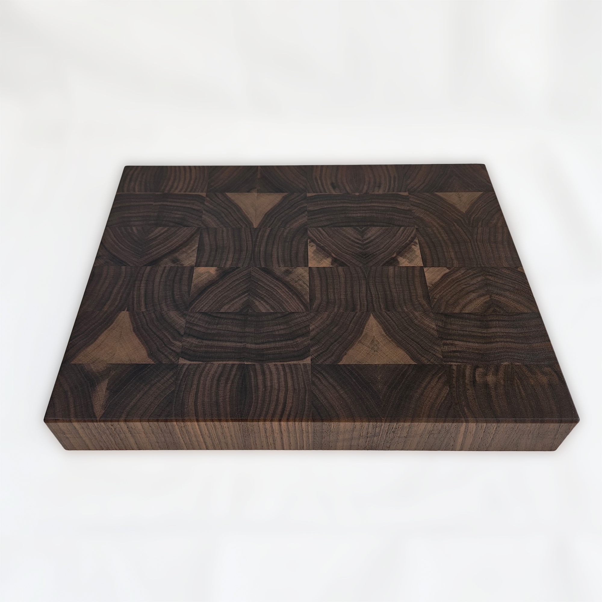 End grain walnut cutting board on countertop for prep and serving