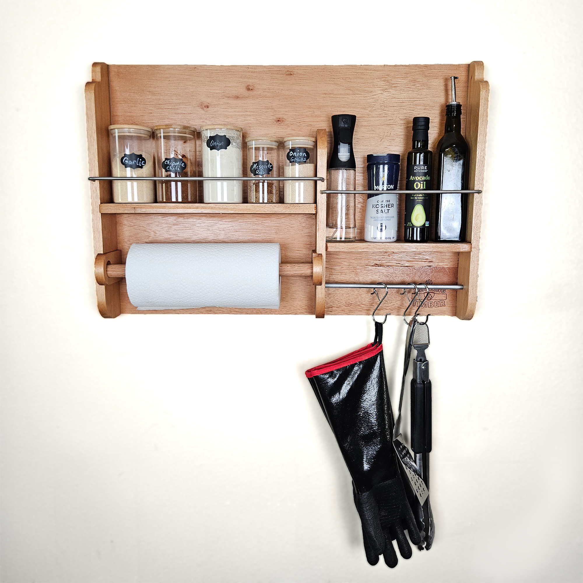 Cedar spice rack mounted on wall holding BBQ rubs