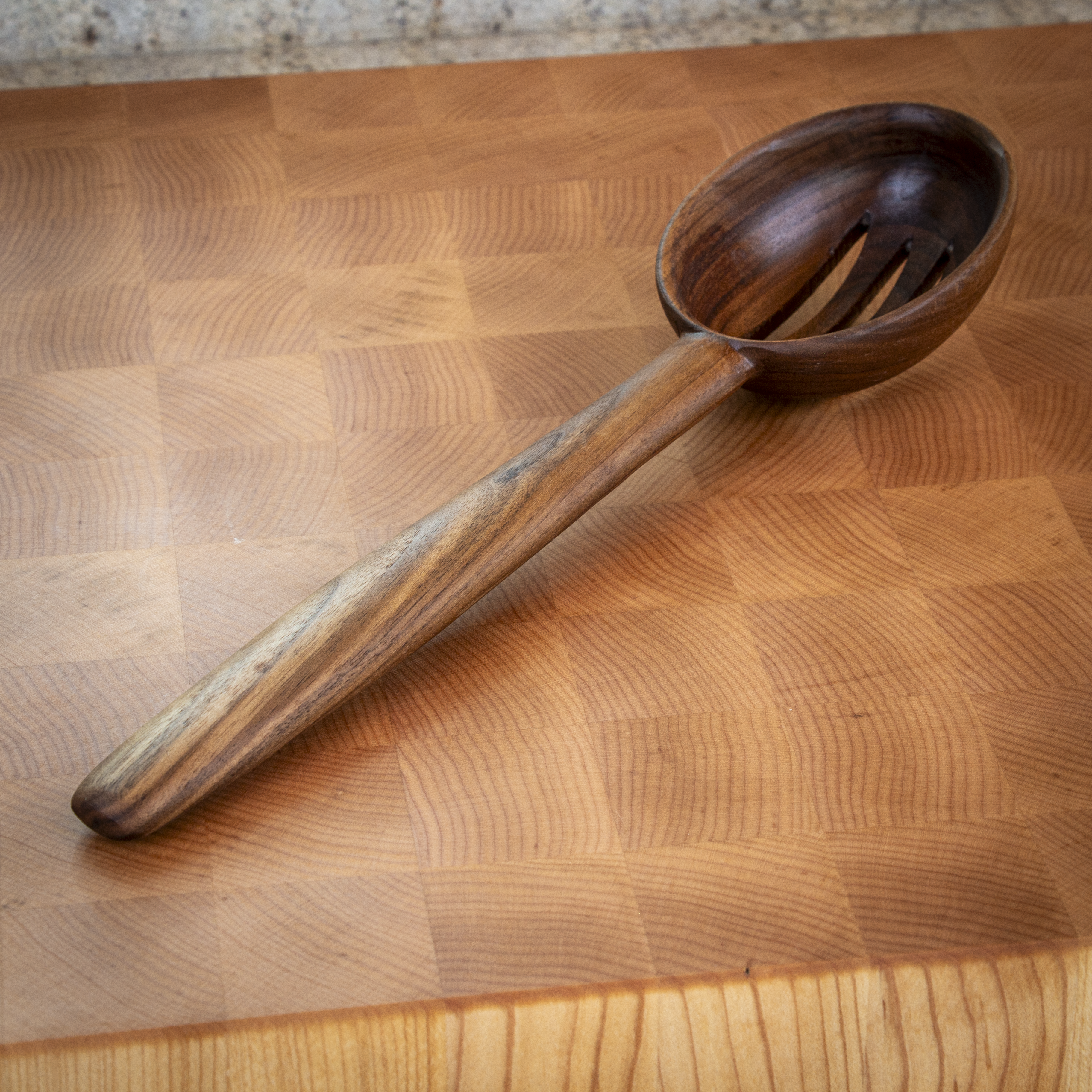 Large slotted wooden cooking spoon for draining and stirring