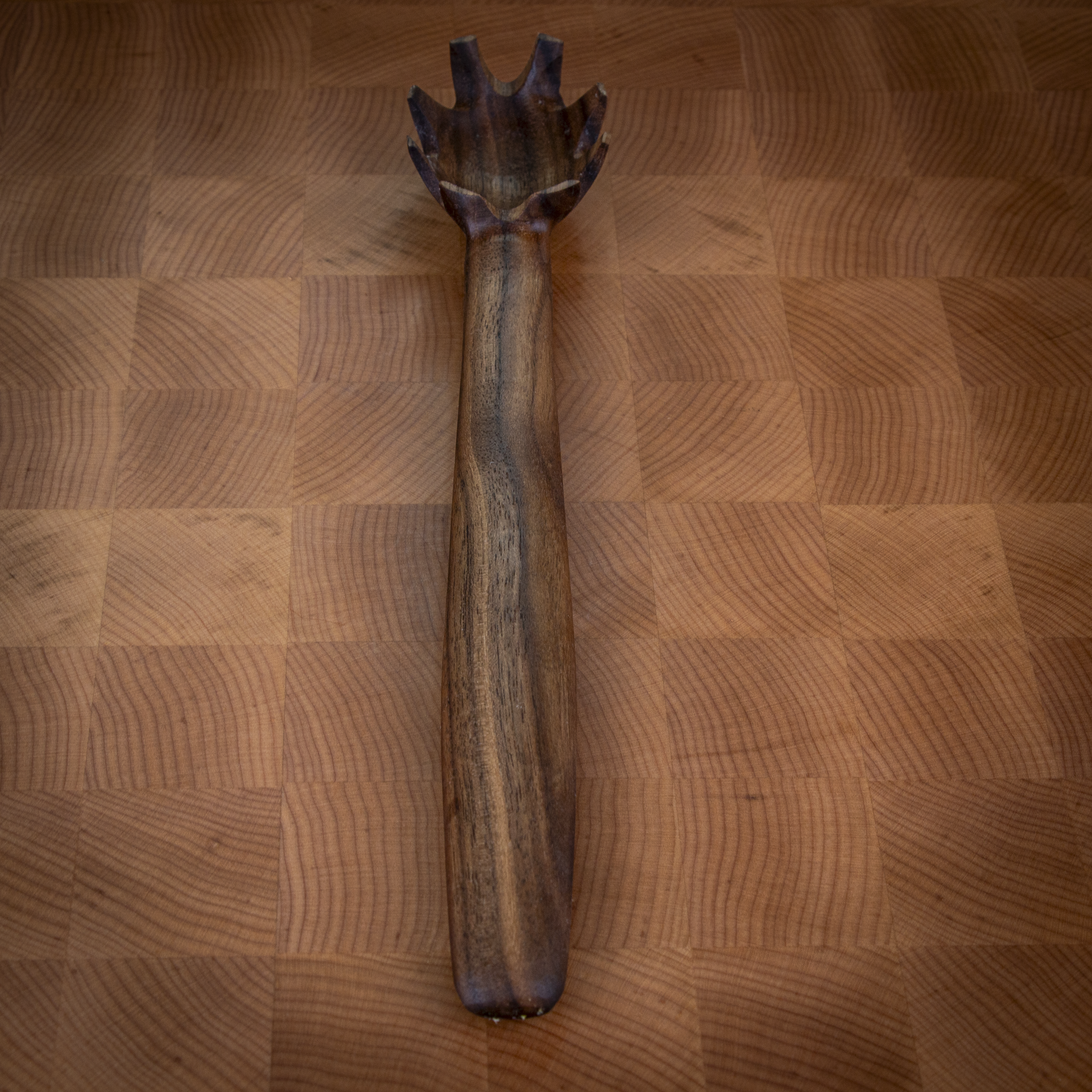 Wooden pasta fork for lifting noodles and elegant kitchen serving